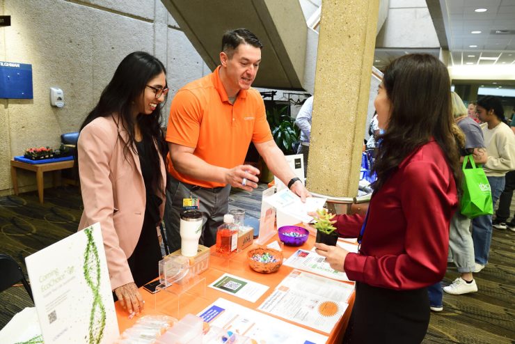 Vendors speak with an attendee at JHU Green Labs Vendor Fair.