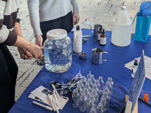 JHU staff creating DIY cleaning solution at a Staff Well Being Day event in April 2025.