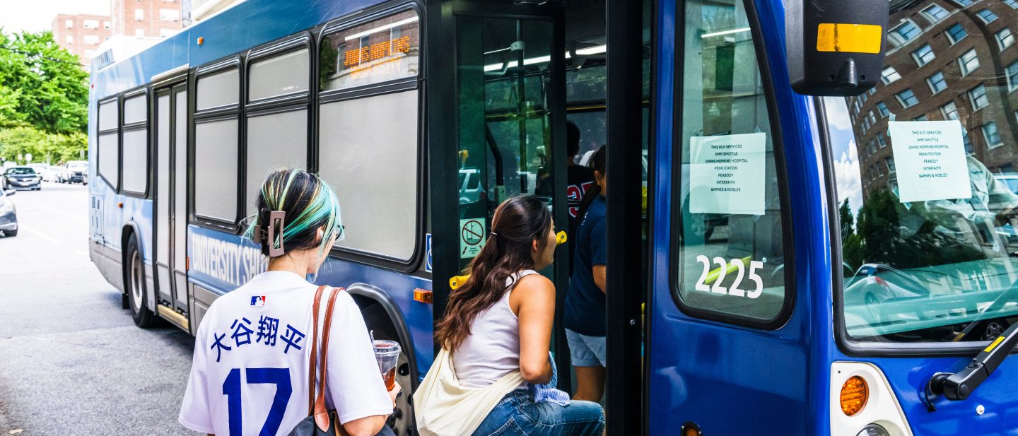 Students using the JHU shuttle bus.